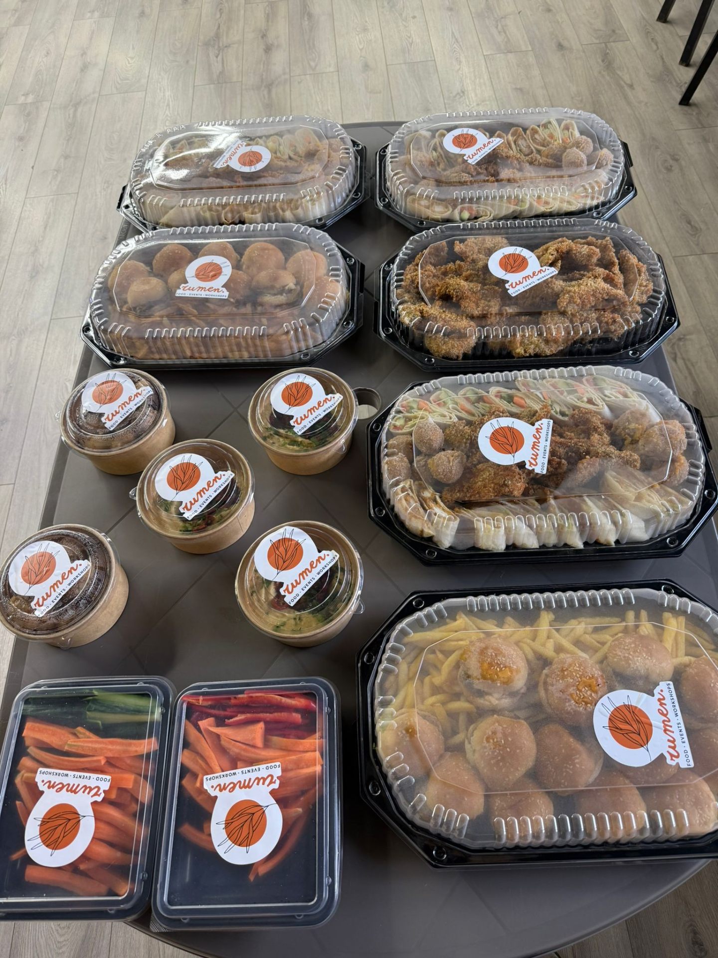 Branded rumen. platters and bowls laid out for an event catering setup