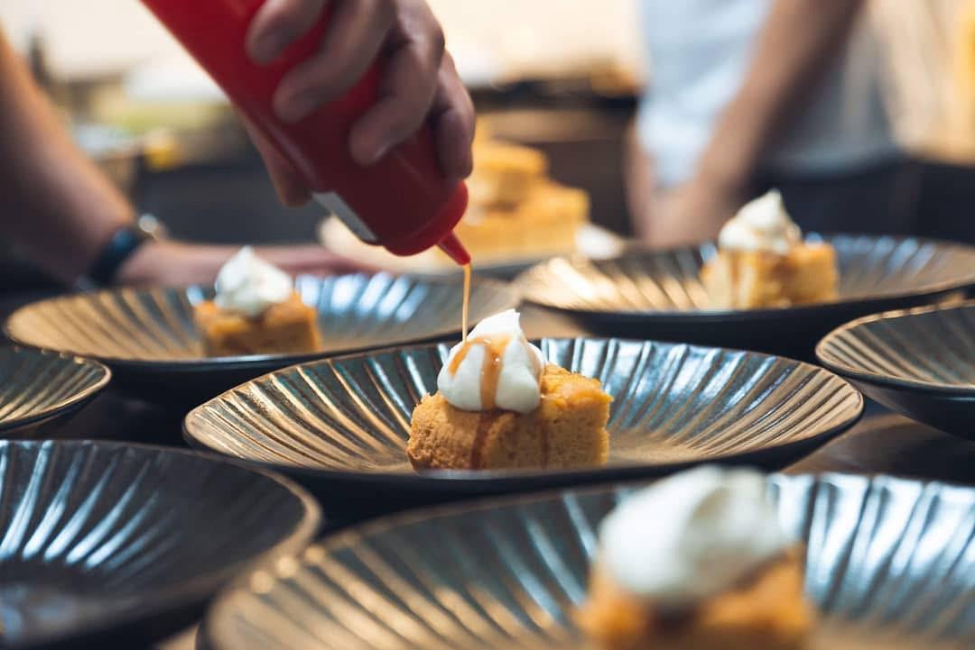 Plated dessert with caramel sauce being drizzled at a private dinner