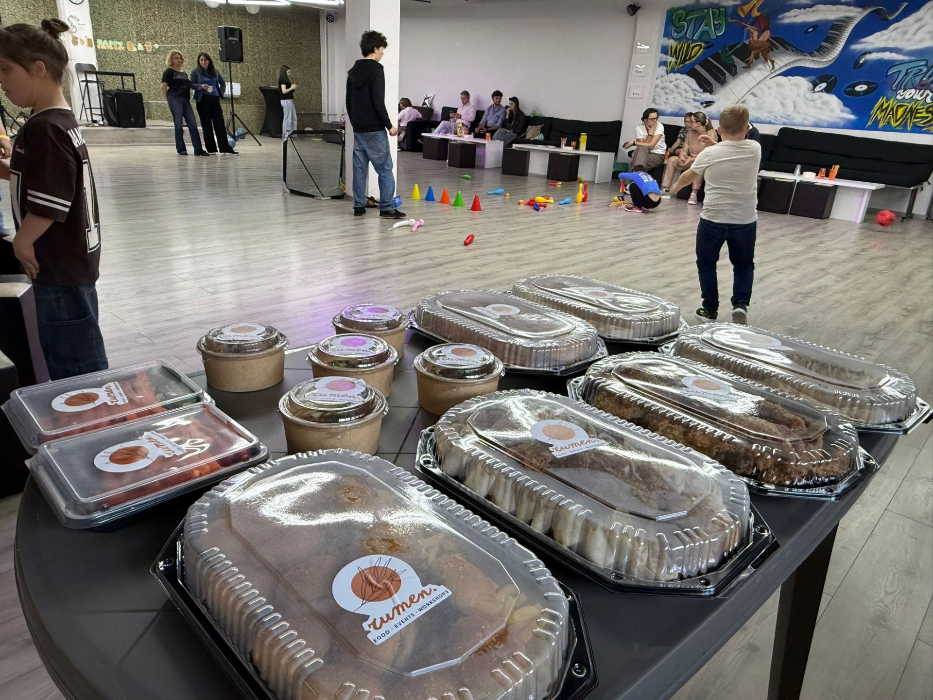 Event room setup with rumen. catering trays ready for guests